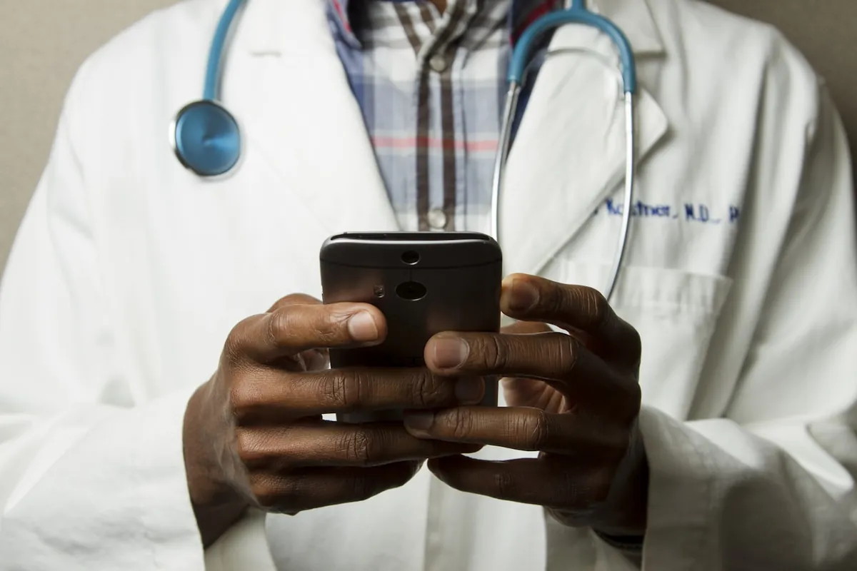 Clinician checking a phone between appointments