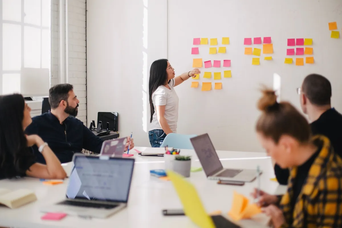 Team mapping out a plan on a whiteboard